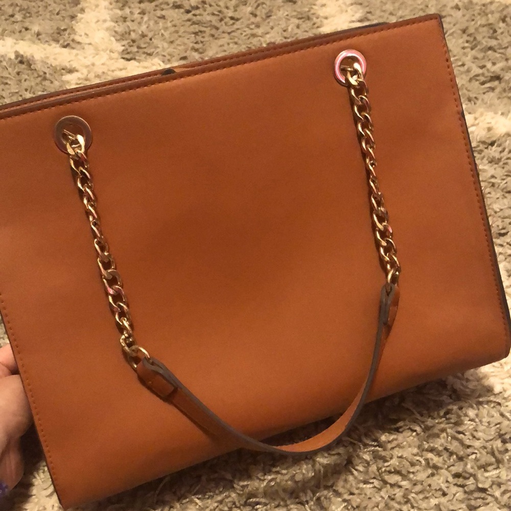 This a light brown a new day purse